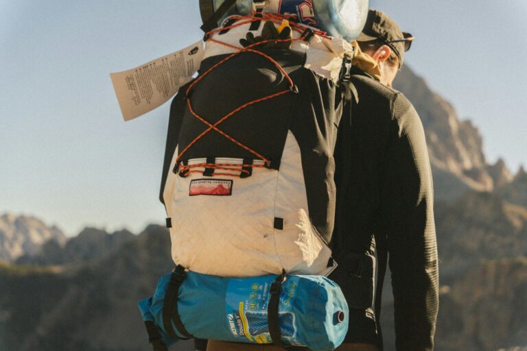 Hiker with large backpack in mountains